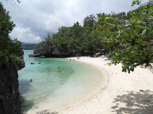 The C-shaped beach on the other side of the diving platform